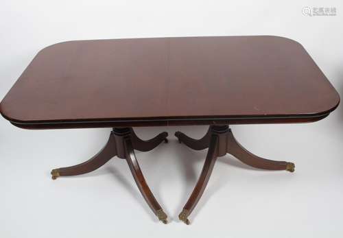 A Regency style mahogany twin pedestal extending dining table,