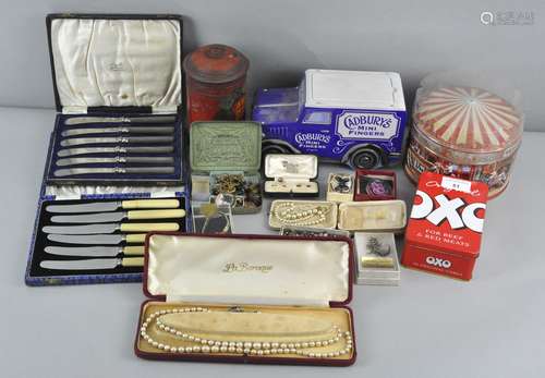 A collection of assorted costume jewellery, cased flatware and vintage advertising tins,