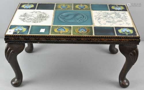 A rectangular occasional table, inlaid with Art Nouveau and other tiles,