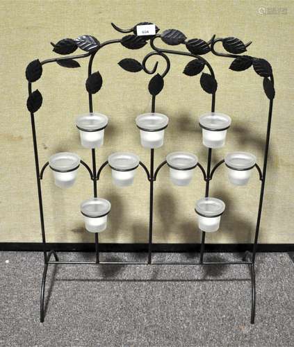 A wrought iron tea tree light holder screen,