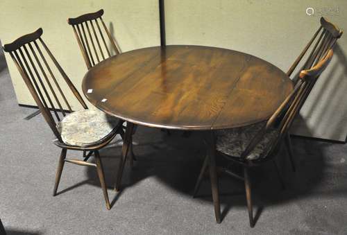 A mid century vintage Ercol beech and elm drop leaf table of oval form with four matching chairs,