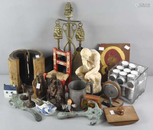 A collection of assorted items, including a brass fire companion set, religious wooden carvings,