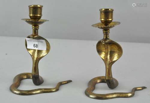 A pair of 20th century Benares brass candlesticks in the form of Cobra's,