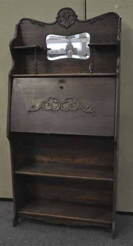 An early 20th century oak student's Bureau with mirrored back, fall front door with fitted interior,