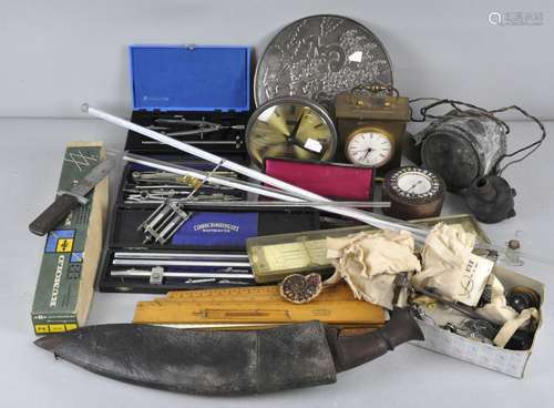 An assortment of various collectables, including a Kukri knife, mercury filled clock pendulum,