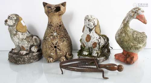 A collection of four small garden ornaments in the forms of a goose, cat and dogs.