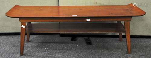 A 1960's stained beech veneered surf board coffee table with under shelf,