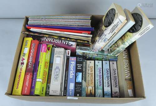 A collection of numerous novels and other books including Dan Brown volumes and the Hobbit