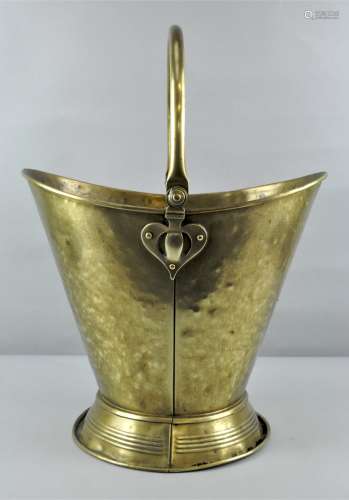 An early 20th century Arts & Crafts Brass coal bucket with swing handle to top with tapered base,