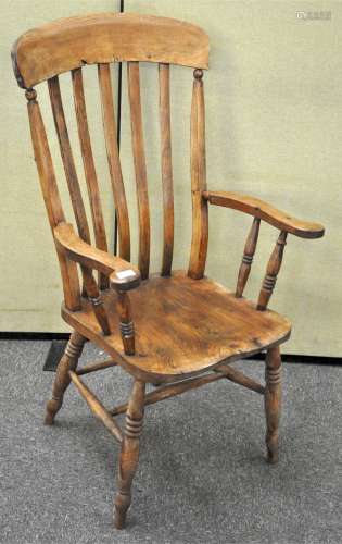 A late 19th century Elm farmhouse chair, having tall rail backrest, squared saddle seat,