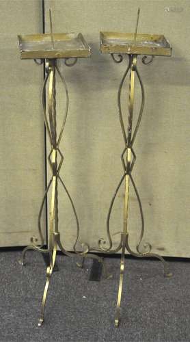 A pair of metal Pricket candlestick stands being painted gold. Measures; 116cm.