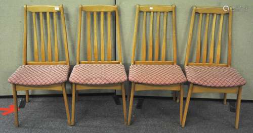 A set of four 20th Century beech wood dining chairs,