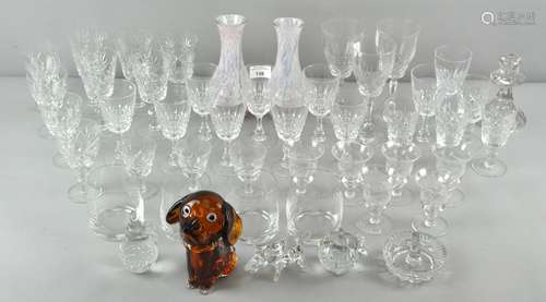 A collection of glassware, including a candlestick and drinking glasses,