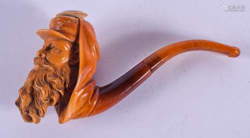 A 19TH CENTURY CARVED MEERSCHAUM AND AMBER PIPE formed as a bearded male. 11.5 cm wide.