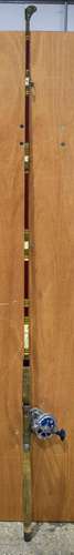 A VINTAGE FISHING ROD with dolphin 615 Olympic reel. 190 cm long.