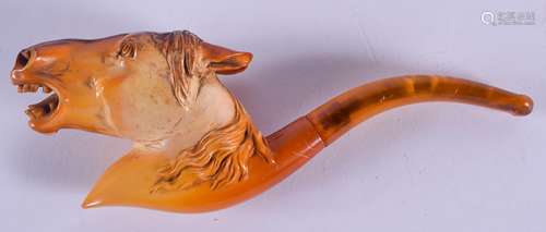 A RARE 19TH CENTURY CARVED MEERSCHAUM AND AMBER PIPE formed as horses head. 17 cm wide.