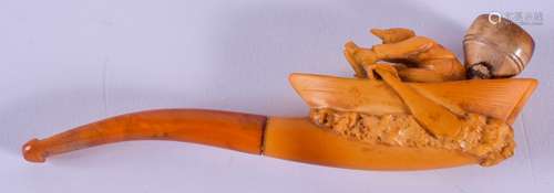 A 19TH CENTURY CARVED MEERSCHAUM AND AMBER PIPE formed as a man rowing upon his boat. 13.5 cm wide.