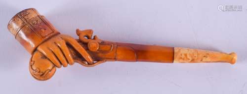 A RARE 19TH CENTURY CARVED MEERSCHAUM AND AMBER PIPE formed as a hand holding a musket. 13 cm wide.