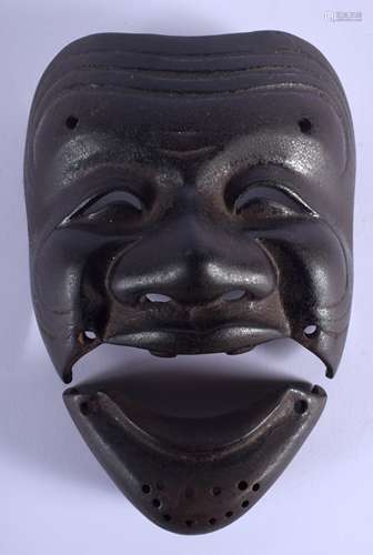 AN 18TH/19TH CENTURY JAPANESE EDO PERIOD IRON KARURA SOMEN modelled as a jovial male. 19 cm x 10 cm.