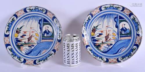 A PAIR OF EARLY 18TH CENTURY ENGLISH DELFT TIN GLAZED FAIENCE DISHES C1730 painted with a boy in a w