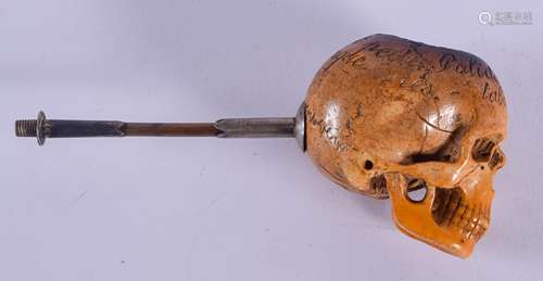 A RARE 19TH CENTURY CARVED MEERSCHAUM AND AMBER PIPE formed as an inscribed skull. 12.5 cm wide.