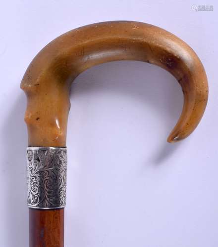 A 19TH CENTURY CONTINENTAL CARVED RHINOCEROS HORN WALKING CANE with silver mounts. 88 cm long.