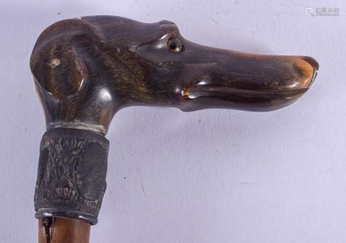 A 19TH CENTURY CARVED RHINOCEROS HORN HANDLED WALKING CANE with white metal mounts. 85 cm long.