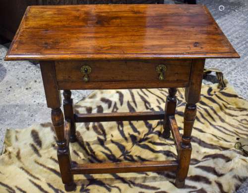 AN EARLY 18TH CENTURY FRUITWOOD SINGLE DRAWER TABLE with rectangular stretcher and brass drop handle