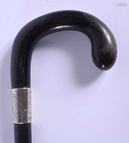 A 19TH CENTURY CONTINENTAL CARVED BUFFALO HORN WALKING CANE with silver mounts. 88 cm long.