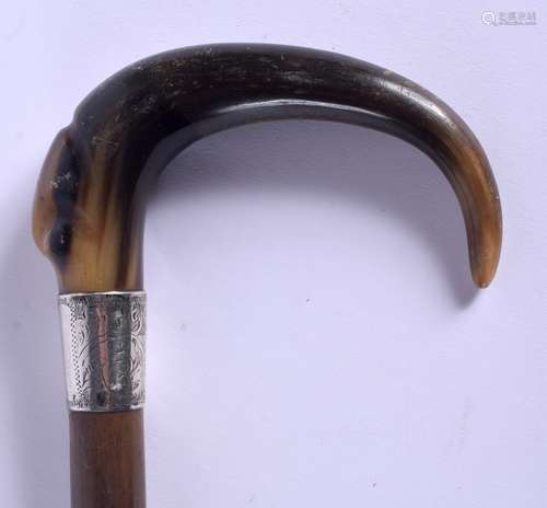 A 19TH CENTURY CONTINENTAL CARVED BUFFALO HORN WALKING CANE with silver mounts. 88 cm long.