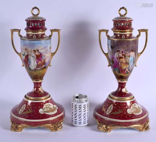 A LARGE PAIR OF EARLY 20TH CENTURY VIENNA TWIN HANDLED PORCELAIN VASES AND COVERS painted with figur