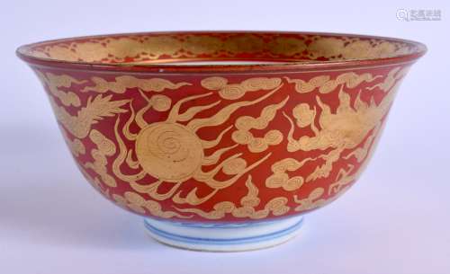A 19TH CENTURY JAPANESE MEIJI PERIOD KUTANI PORCELAIN BOWL painted upon a coral ground with dragons.