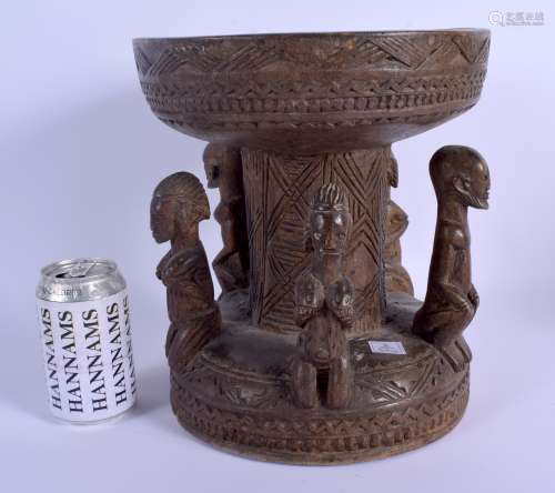AN EARLY 20TH CENTURY AFRICAN DOGON TRIBAL STOOL formed with five opposing figures. 28 cm x 20 cm.