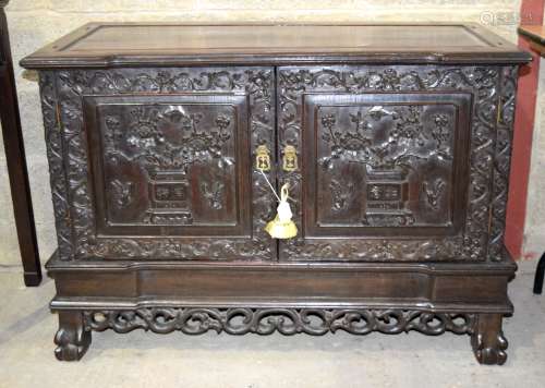 A 19TH CENTURY CHINESE HONGMU HARDWOOD RECTANGULAR STANDING CABINET the doors decorated with panels