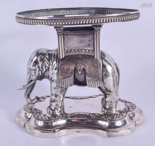 A RARE 19TH CENTURY CONTINENTAL SILVER MODEL OF A ROAMING ELEPHANT modelled upon a shaped base, embe