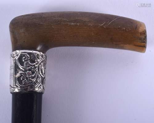 A 19TH CENTURY CONTINENTAL CARVED RHINOCEROS HORN HANDLED WALKING CANE with silver mounts. 87 cm lon