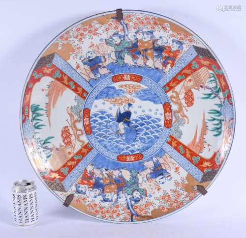 A VERY LARGE 19TH CENTURY JAPANESE MEIJI PERIOD IMARI CHARGER painted with boys within landscapes. 4