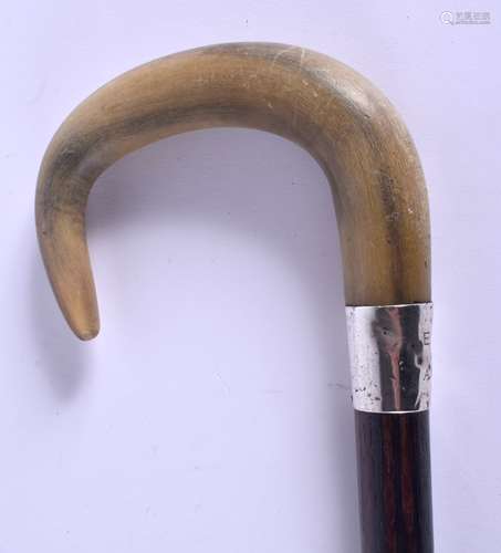 A 19TH CENTURY CONTINENTAL CARVED RHINOCEROS HORN WALKING CANE with silver mounts. 88 cm long.