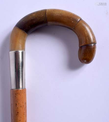 A 19TH CENTURY CONTINENTAL CARVED RHINOCEROS HORN WALKING CANE with silver mounts. 88 cm long.