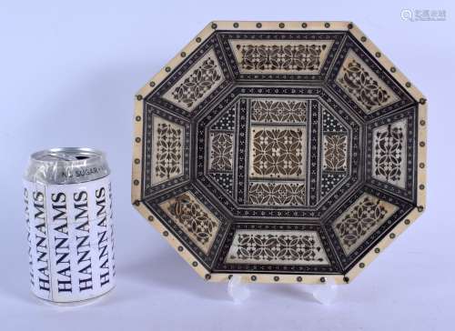 A 19TH CENTURY ANGLO INDIAN CARVED IVORY OCTAGONAL DISH decorated with flowers and geometric motifs.