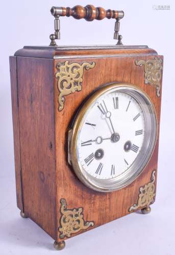 A LATE 19TH CENTURY OAK CASED MANTEL CLOCK with brass embellishments. 19 cm high.