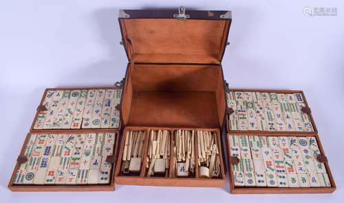 A VINTAGE CHINESE LEATHER CASED BAMBOO AND BONE MAHJONG SET with white metal mounts. 24 cm x 13 cm.