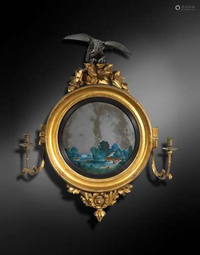 A RARE REGENCY CONVEX WALL MIRROR ATTRIBUTED TO TH…