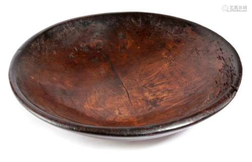 A TREEN STAINED ELM DAIRY BOWL 19TH CENTURY the ex…