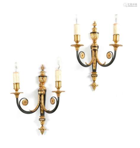 A SET OF FOUR GILT BRASS AND EBONISED TWIN LIGHT W…
