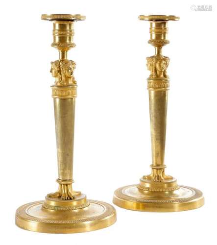 A NEAR PAIR OF FRENCH EMPIRE ORMOLU CANDLESTICKS I…