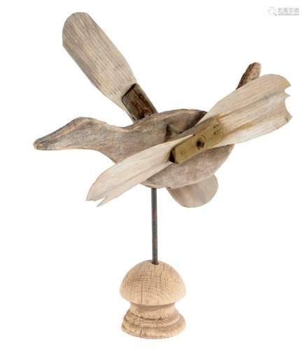 A FOLK ART CARVED WOOD WHIRLIGIG in the form of a …