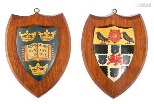 A PAIR OF CARVED OAK AND PAINTED HERALDIC SHIELDS …