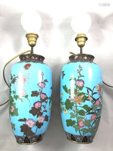 Japan pair of vases decorated with cloisonné enamels on copper with a polychrome decoration on a blue background of clematis, lilies and chrysanthemums. Japan around 1900. One of the vases has been sunk. Height. 34 cm.