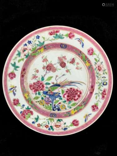 China - Porcelain and enamels of the rose family. A plate decorated with phoenix and peonies in the basin, flowers and butterflies on the marli. China 18th century - Starry crack on the back. Diameter: 23 cm.
